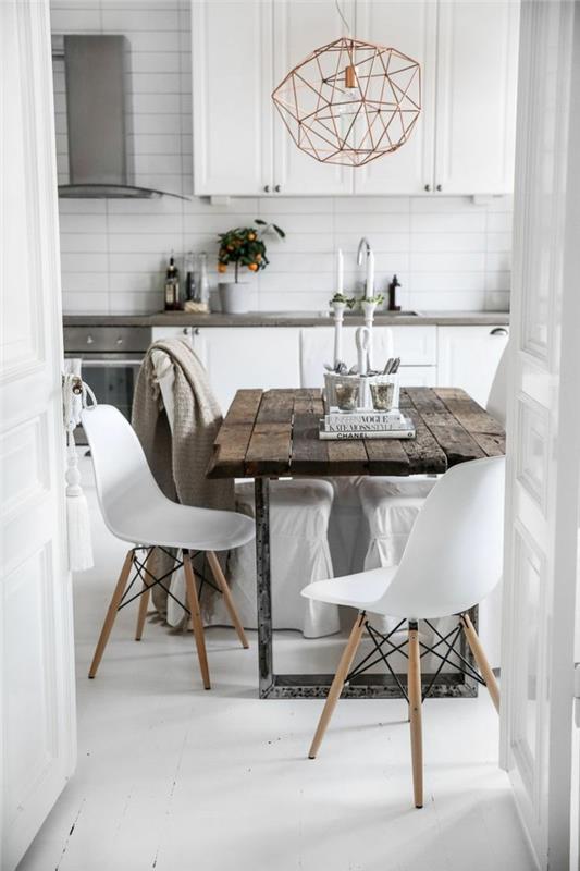 Skandinaavinen ruokasalin puinen pöytä ja valkoiset tuolit