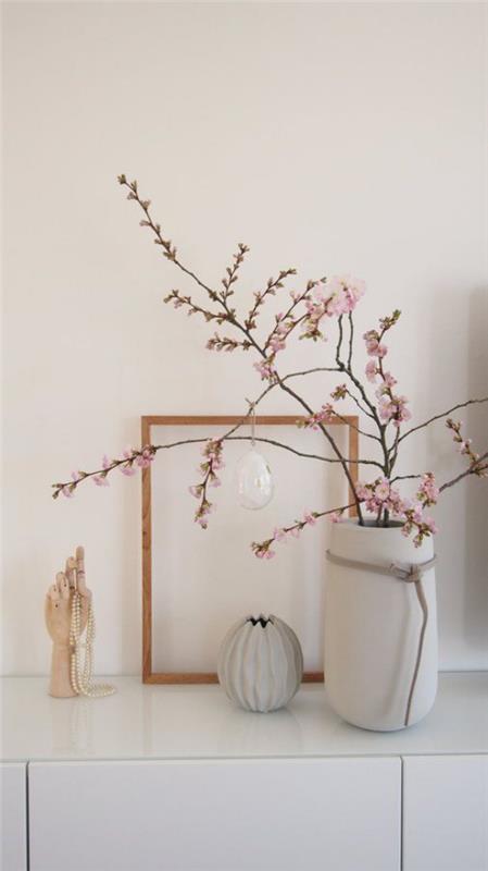 Skandinaavinen kevätkoriste pukeutujalla tyylikäs asetelma vaaleanpunaisista kirsikankukista