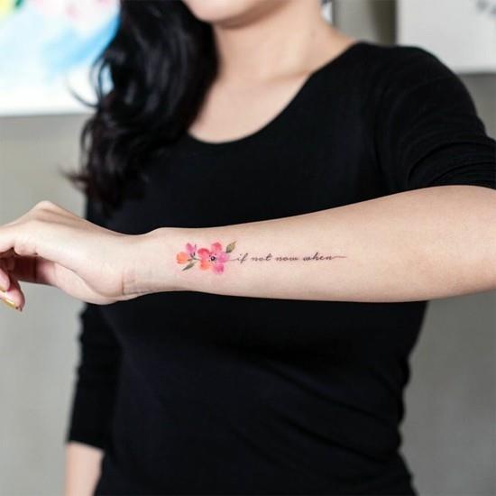 kyynärvarren kirsikankukka -tatuointi kirjoituksella