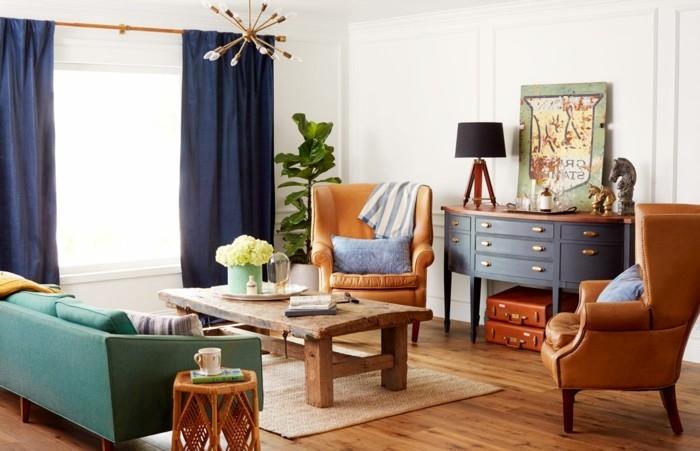 vinage -sisustustyyli antiikkinen pukeutujanahkainen nojatuoli vihreä sohva maalaismainen puinen pöytä