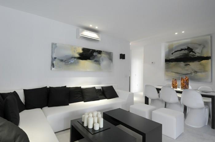 seinän suunnittelu olohuoneen seinän suunnittelu valkoiset huonekalut mustat heitotyynyt kynttilät