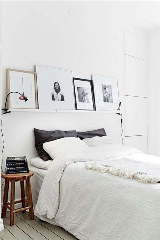 valkoinen makuuhuone valkoiset seinät seinähylly kuvat mustat heitotyynyt