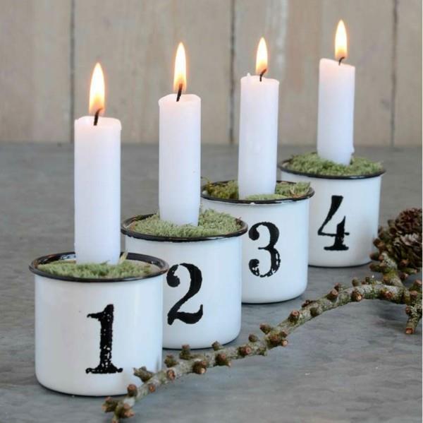 valkoiset pitkät kynttilät sammalimukit tekevät oman adventtiseppeleen