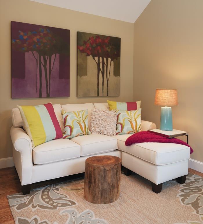 olohuone beige vaaleat seinät valkoinen sohva maalaismainen sohvapöytä kukkamatto