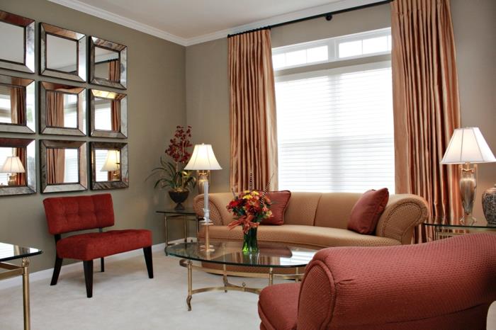 olohuone maalausideoita beige seinät punainen huonekalut soikea sohvapöytä
