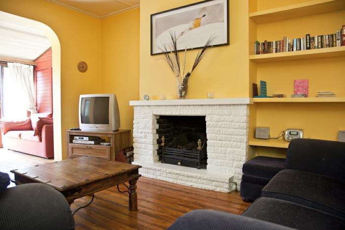 olohuoneen maalausideoita keltainen seinämaali takka musta olohuoneen huonekalut